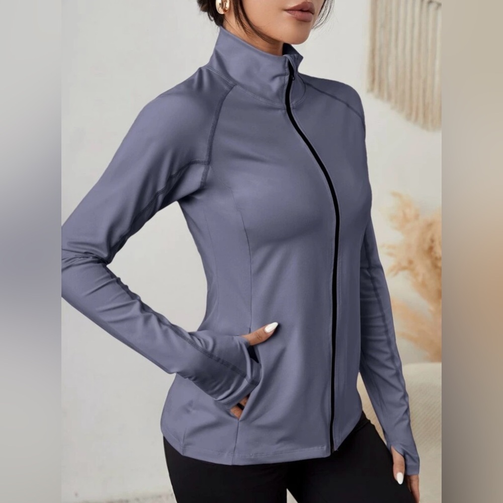 Brand new with tags zip up slant pocket warming sports jacket with thumb holes.